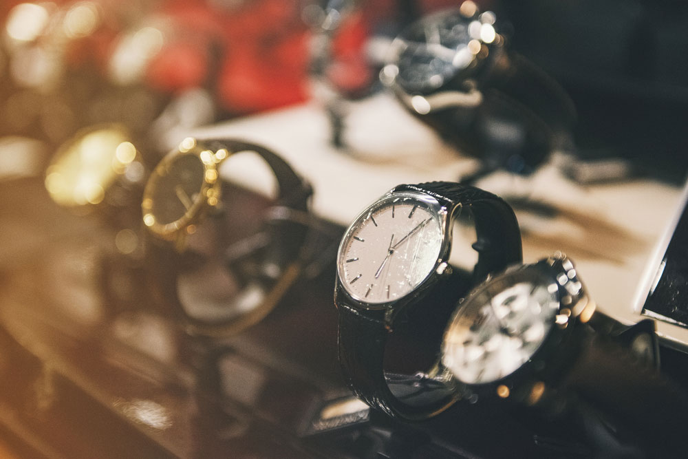 Luxury Rolex watches displayed with a soft bokeh effect as the focus blurs to the left-hand side.