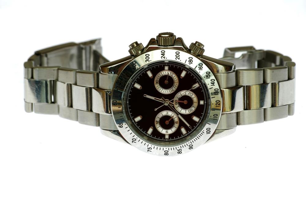 A close up shot of a rolex wrist watch isolated on a white background.