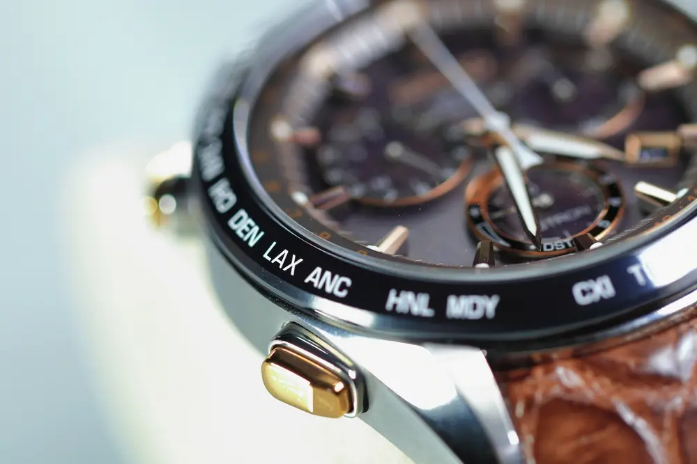 Close-up of a world-time luxury watch with gold accents, supporting content on when to sell your luxury watch.