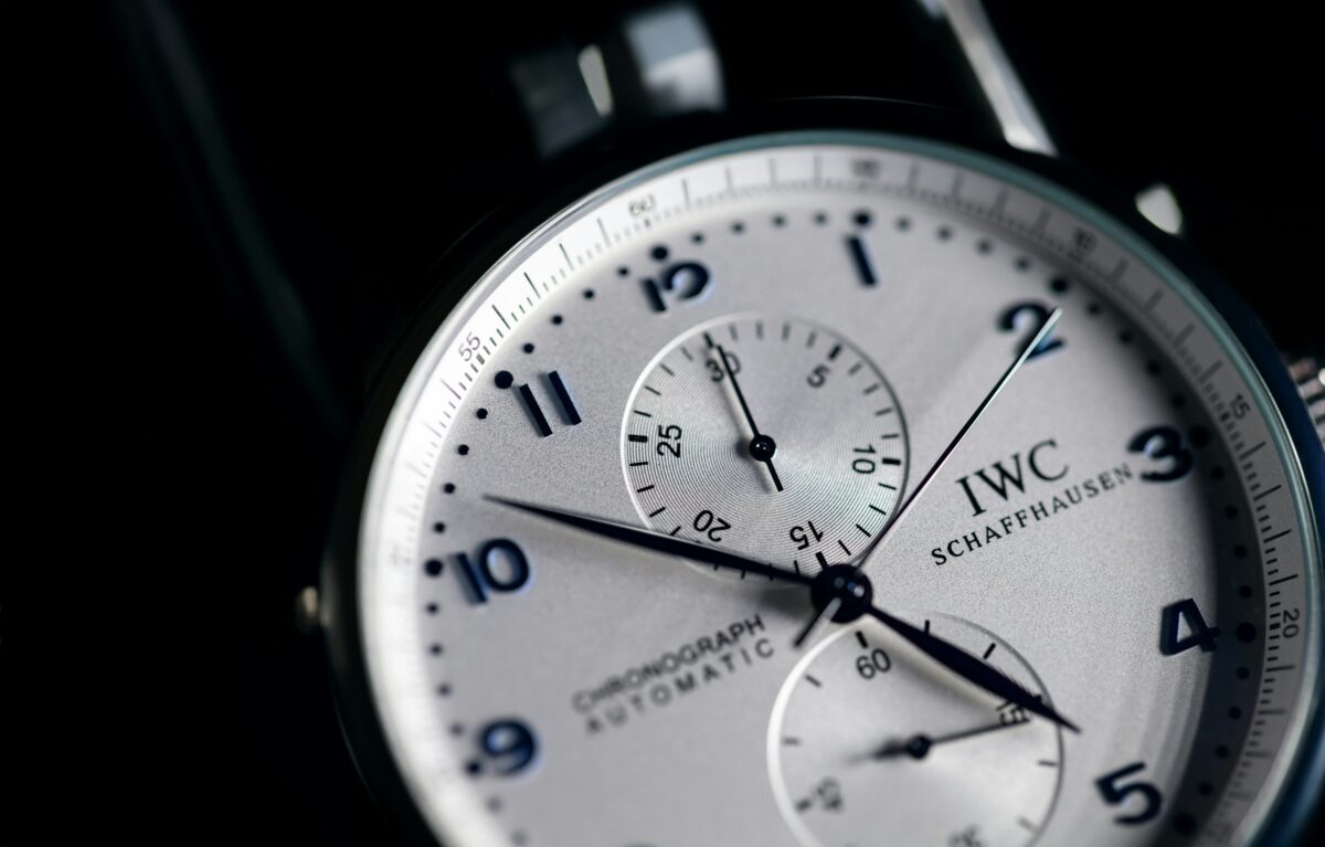 Close-up of an IWC Schaffhausen chronograph with a silver dial, blue Arabic numerals and two subdials.