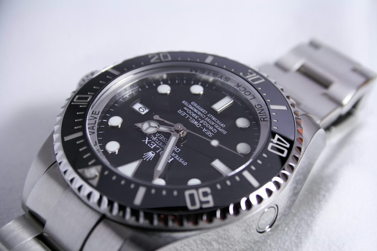 Angled close-up of a Rolex Deepsea Sea-Dweller with a black dial, rotating bezel and steel bracelet