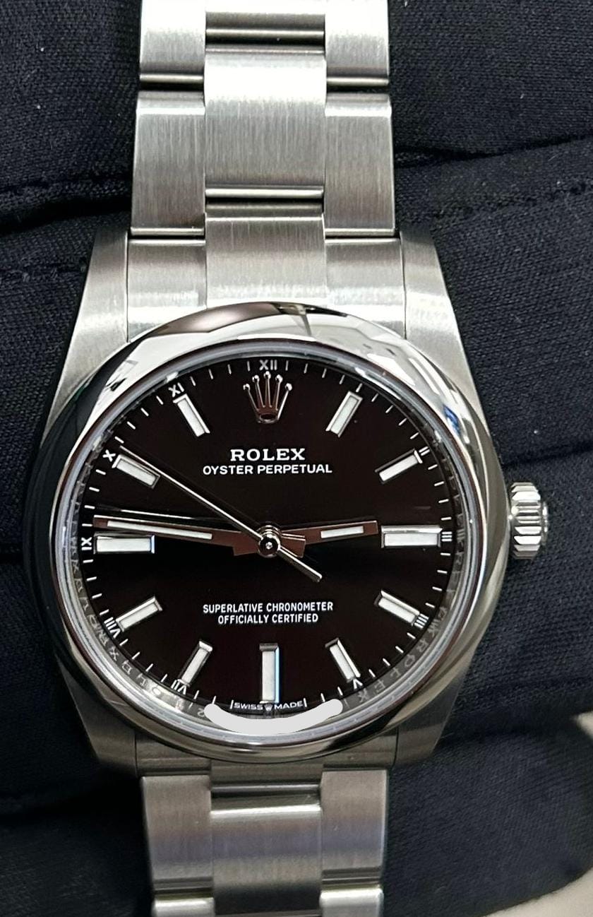 Rolex Oyster Perpetual with a black dial, smooth bezel and stainless steel Oyster bracelet